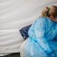 A medical assistant rests while waiting for patients at an abandoned Dave & Buster’s that’s been converted to a large-scale covid-19 testing facility on January 8, 2022 in Houston, Texas.